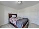 Comfortable carpeted bedroom features a dark wood bed frame and neutral walls at 645 Earlham Dr, Suwanee, GA 30024