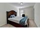 Bedroom with carpet, a dark wooden bed frame, a window, and a study desk at 645 Earlham Dr, Suwanee, GA 30024