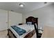 Comfortable bedroom features a dark wood bed frame and built-in desk area at 645 Earlham Dr, Suwanee, GA 30024