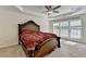 This bedroom features a tray ceiling, ceiling fan, and bright windows at 645 Earlham Dr, Suwanee, GA 30024