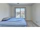 Small bedroom with carpet and a large window at 645 Earlham Dr, Suwanee, GA 30024