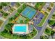 Aerial view of community pool and tennis courts surrounded by homes and green space at 645 Earlham Dr, Suwanee, GA 30024