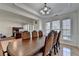 Spacious dining room featuring a large table, chandelier, and hardwood floors at 645 Earlham Dr, Suwanee, GA 30024