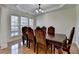 Elegant dining room with a large table, hardwood floors, and natural light at 645 Earlham Dr, Suwanee, GA 30024