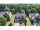 An aerial view of a well-maintained two-story home featuring a lush front lawn and a two-car garage at 645 Earlham Dr, Suwanee, GA 30024