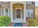 A warm and inviting front entrance with a covered porch and manicured shrubbery at 645 Earlham Dr, Suwanee, GA 30024