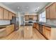 Modern kitchen with stainless steel appliances, granite countertops, and hardwood floors at 645 Earlham Dr, Suwanee, GA 30024