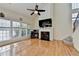 Living room showcasing fireplace, ceiling fan, and staircase at 645 Earlham Dr, Suwanee, GA 30024