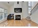 Living room with high ceilings, fireplace, hardwood floors, and stairs at 645 Earlham Dr, Suwanee, GA 30024