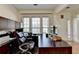 Functional home office space featuring built-in shelves, desk, and ample natural light at 645 Earlham Dr, Suwanee, GA 30024