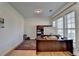 Well-lit home office with hardwood floors, desk, and a large window at 645 Earlham Dr, Suwanee, GA 30024