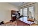 Cozy home office featuring a large desk, built-in shelves, and a comfortable workspace at 645 Earlham Dr, Suwanee, GA 30024