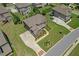 Aerial view of a well-manicured lawn and landscaping surrounding the brick home with a long drive at 2520 Wood Fern Ln, Cumming, GA 30041