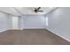 Basement featuring carpet flooring, a ceiling fan, and a large window for natural light at 2520 Wood Fern Ln, Cumming, GA 30041