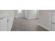 Unfinished basement area with gray carpet, neutral walls, and multiple access doors at 2520 Wood Fern Ln, Cumming, GA 30041