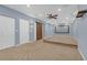 Finished basement with a projection screen, sliding barn door, and carpet flooring at 2520 Wood Fern Ln, Cumming, GA 30041