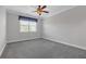 Clean and carpeted bedroom featuring a ceiling fan and neutral tones at 2520 Wood Fern Ln, Cumming, GA 30041