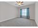 Spacious bedroom with gray carpet, light-colored walls and window dressed in teal curtains at 2520 Wood Fern Ln, Cumming, GA 30041