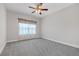 Bright bedroom featuring neutral walls, plush gray carpet, and a ceiling fan at 2520 Wood Fern Ln, Cumming, GA 30041