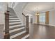 Inviting entryway with hardwood floors, staircase, and ample natural light at 2520 Wood Fern Ln, Cumming, GA 30041