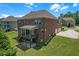 Brick home featuring a deck, patio, and a lush green yard with mature trees at 2520 Wood Fern Ln, Cumming, GA 30041
