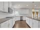 Contemporary kitchen with white cabinets, stainless steel appliances, granite countertops, and a stylish tile backsplash at 2520 Wood Fern Ln, Cumming, GA 30041