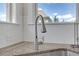 Close up shot of modern stainless steel kitchen faucet and granite countertop against white tile backsplash at 2520 Wood Fern Ln, Cumming, GA 30041