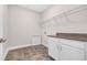 Functional laundry room with tiled floors, countertop and wire shelving at 2520 Wood Fern Ln, Cumming, GA 30041