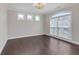 Inviting room boasts dark hardwood floors, a modern ceiling light, and bright, natural light at 2520 Wood Fern Ln, Cumming, GA 30041