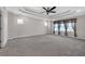 Spacious main bedroom with coffered ceilings, neutral walls, and three large windows at 2520 Wood Fern Ln, Cumming, GA 30041