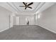 Very spacious main bedroom with coffered ceilings, light-colored walls, and gray carpet at 2520 Wood Fern Ln, Cumming, GA 30041