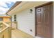 View of the back porch featuring a wooden railing and new exterior door at 3275 Clifton Church Se Rd, Atlanta, GA 30316