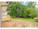 A partial view of the home with a backyard area featuring trees at 3275 Clifton Church Se Rd, Atlanta, GA 30316
