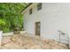 Backyard patio area featuring brick retaining walls and a door leading into the home at 3275 Clifton Church Se Rd, Atlanta, GA 30316