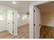 Finished basement area with neutral paint, modern flooring and access to another room at 3275 Clifton Church Se Rd, Atlanta, GA 30316