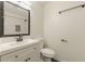 Clean bathroom showcasing a modern vanity with white cabinetry and a toilet with black hardware at 3275 Clifton Church Se Rd, Atlanta, GA 30316