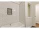 Clean bathtub with white subway tiles and black hardware accents, offering a modern aesthetic at 3275 Clifton Church Se Rd, Atlanta, GA 30316