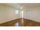Bedroom featuring hardwood floors, ample natural light, and a closet with classic doors at 3275 Clifton Church Se Rd, Atlanta, GA 30316