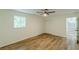 Neutral bedroom featuring a window, ceiling fan, closet and wood-look flooring at 3275 Clifton Church Se Rd, Atlanta, GA 30316