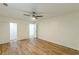 A bedroom with light wood floors and a ceiling fan plus entry door and closet at 3275 Clifton Church Se Rd, Atlanta, GA 30316
