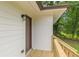 Side view of the house showcasing the entry door and wooden deck at 3275 Clifton Church Se Rd, Atlanta, GA 30316