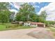 Charming two-story home with a brick exterior, green lawn, and attached two-car garage at 3275 Clifton Church Se Rd, Atlanta, GA 30316