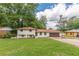 Charming two-story home with a brick exterior, green lawn, and attached two-car garage at 3275 Clifton Church Se Rd, Atlanta, GA 30316
