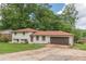 Charming two-story home with a brick exterior, green lawn, and attached two-car garage at 3275 Clifton Church Se Rd, Atlanta, GA 30316