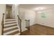 Staircase leading to hallway with hardwood floors and natural light, enhancing the home's appeal at 3275 Clifton Church Se Rd, Atlanta, GA 30316