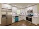 A modern kitchen featuring white cabinets, stainless steel appliances, and wood floors at 3275 Clifton Church Se Rd, Atlanta, GA 30316