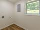 Functional laundry room with a window, tile floor and hook ups for washer and dryer at 3275 Clifton Church Se Rd, Atlanta, GA 30316
