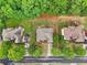 An aerial view of well-spaced homes with lush green lawns and mature trees creating a serene and private residential setting at 3874 Lost Oak Dr, Buford, GA 30519