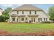 A beautiful backyard featuring a patio, grill, seating area, and spacious green grass at 3874 Lost Oak Dr, Buford, GA 30519