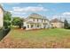 Expansive backyard with green grass and mature trees, offering ample space for outdoor activities and relaxation at 3874 Lost Oak Dr, Buford, GA 30519